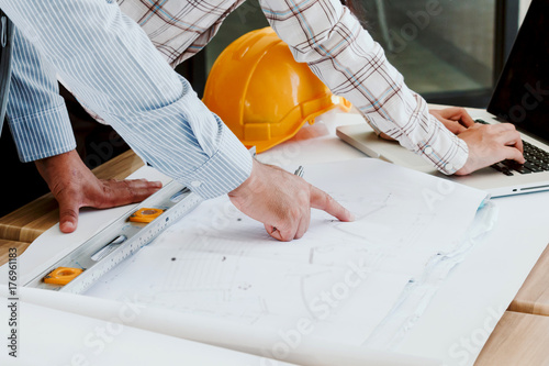 Team engineers working with construction tools on table