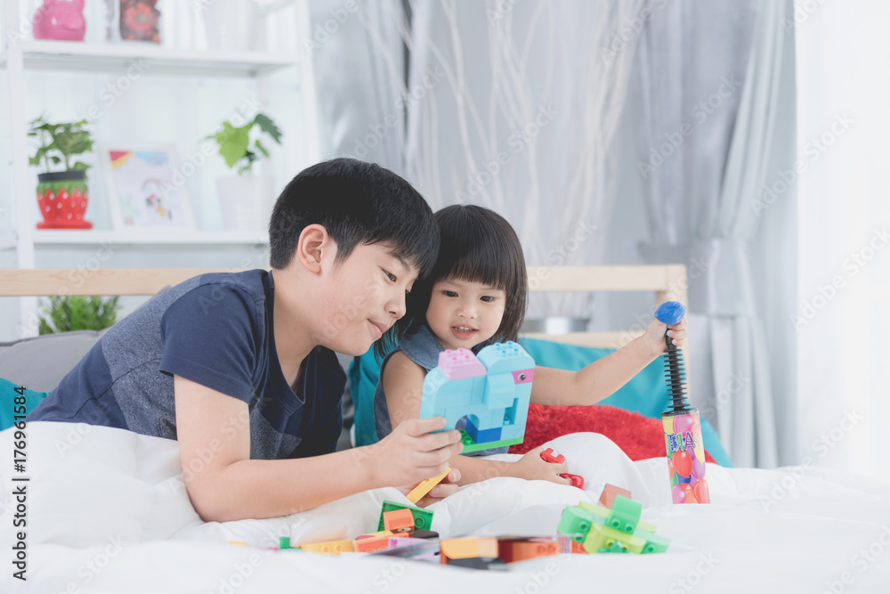 Asian kids siblings brother and sister playing in the constructor block, Asian kids siblings brother and sister playing in the constructor block,