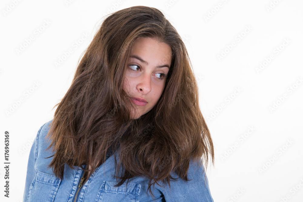 beautiful young woman with long hair looks down on the side beautiful young woman with long hair looks down on the side