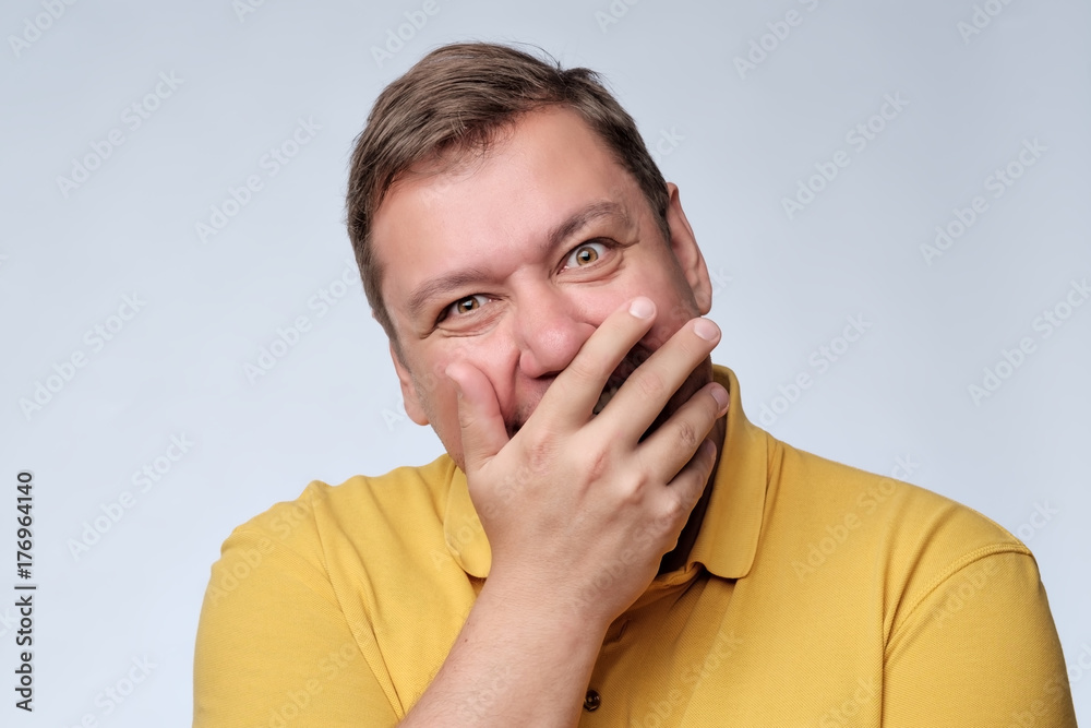 Mature fat man studio portrait. He closes his mouth with delight. Mature fat man studio portrait. He closes his mouth with delight.