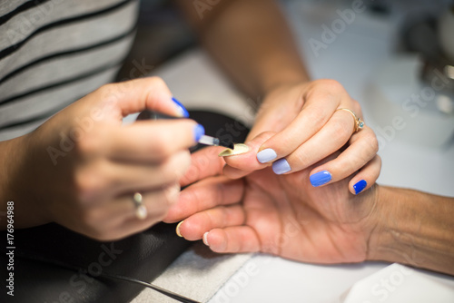 Manicure. Master make nail paint. hands closeup.