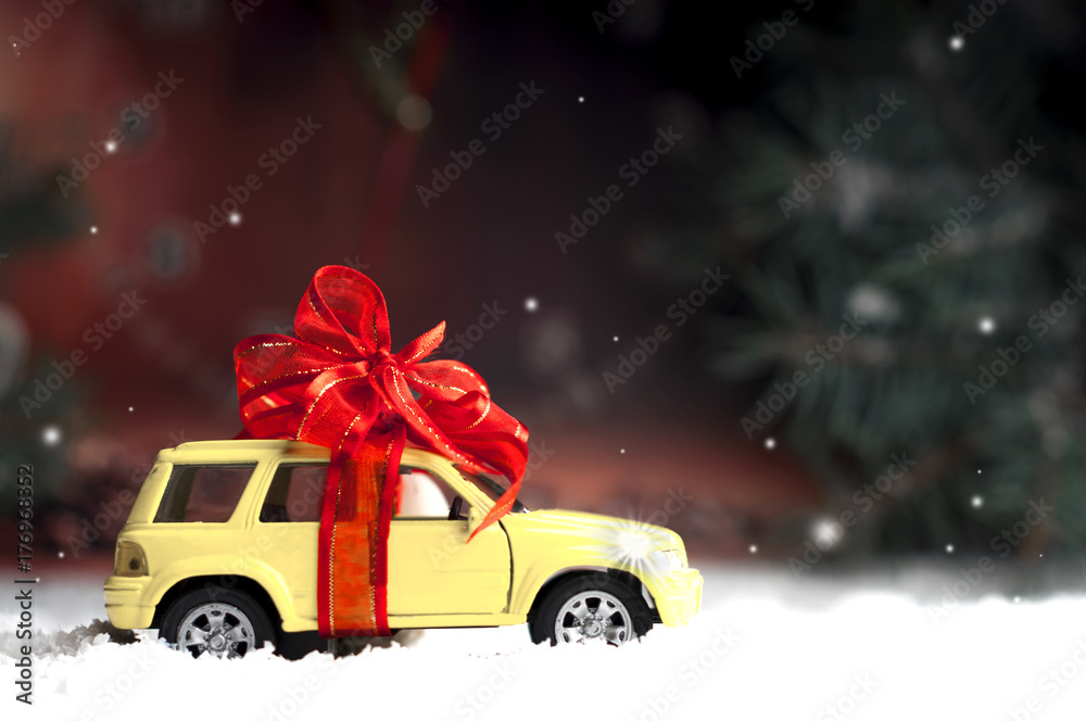 small car with a decorative bow in snow