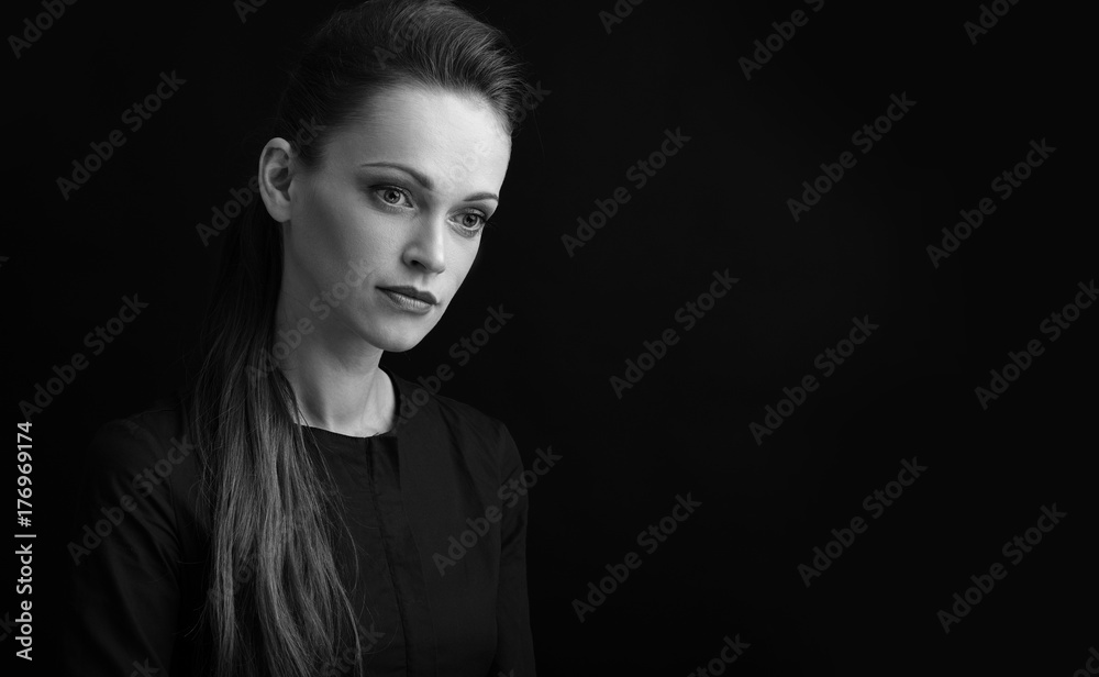 Sad woman over black background with copy space