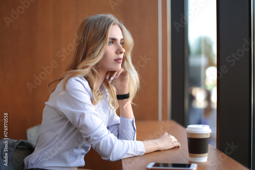 Young woman sitting at tabl...