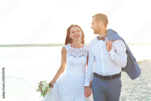 Happy wedding couple on sea...