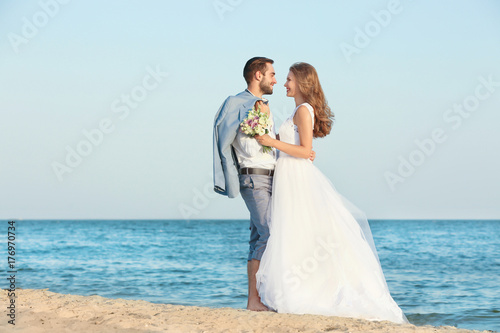 Happy wedding couple on sea...