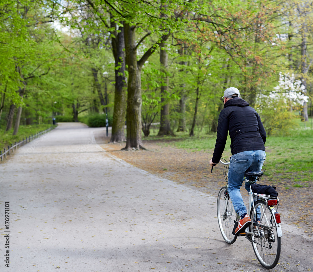 Young man riding on his bike In the park