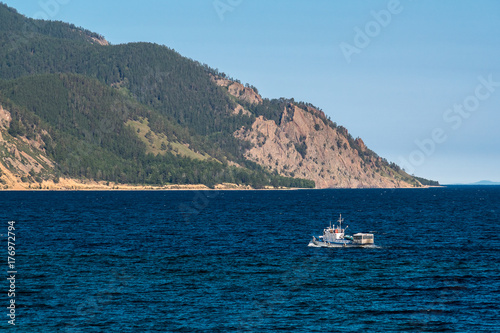 Passenger boat sails on Lake Baikal near Sibiryakov cape