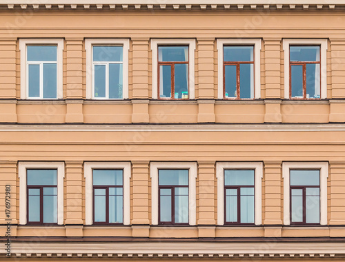 Several windows in a row on facade of urban office building front view, St. Petersburg, Russia