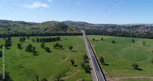 Hume Highway M31 near Gundagai rural NSW town flying above b double lanes with passing traffic towards hill range.
 photo