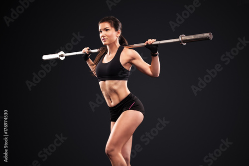 Sporty anf fit beautiful woman exercising workout training with barbell. Fitness motivation.