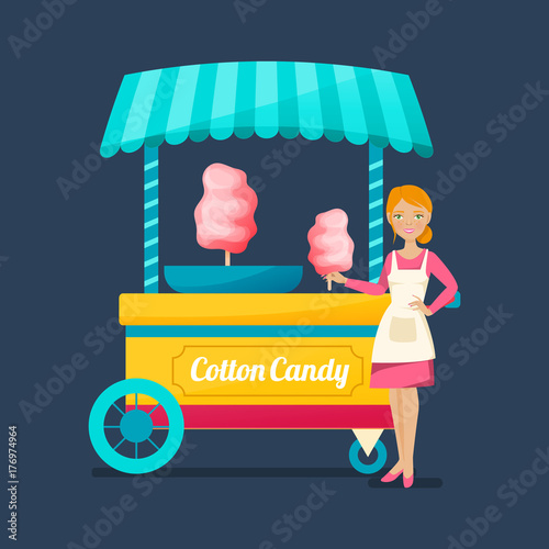 Beautiful saleswoman of sweet cotton wool, near counter with sweet.