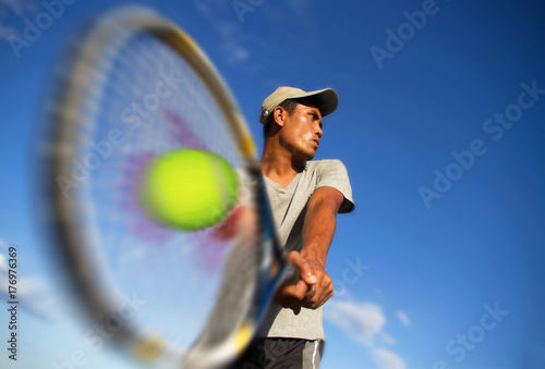 Young men player tennis With sky blue