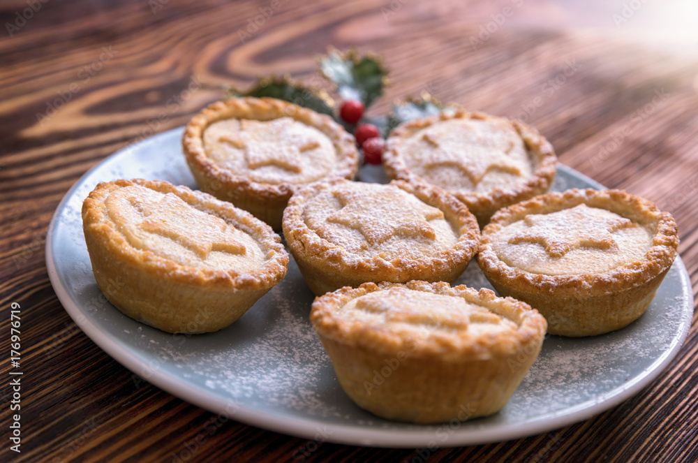 Homemade, british Mince Pies for Christmas on a blue plate on wooden table