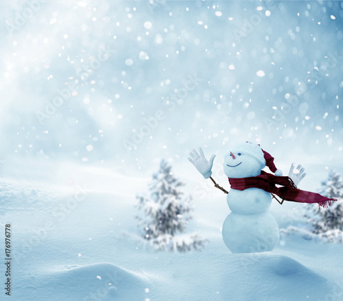 Merry christmas and happy new year greeting card with copy-space.Happy snowman standing in winter christmas landscape.Snow background