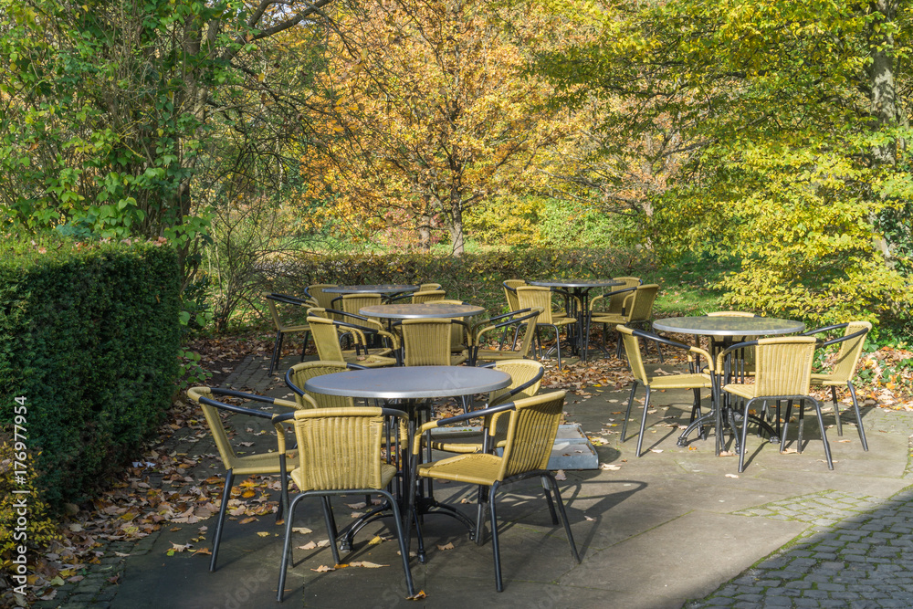 Empty chairs and tables in a beer garden in autumn