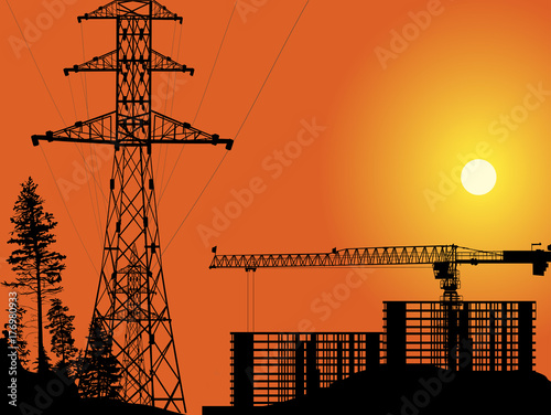 buildings and electric pylon at orange sunset