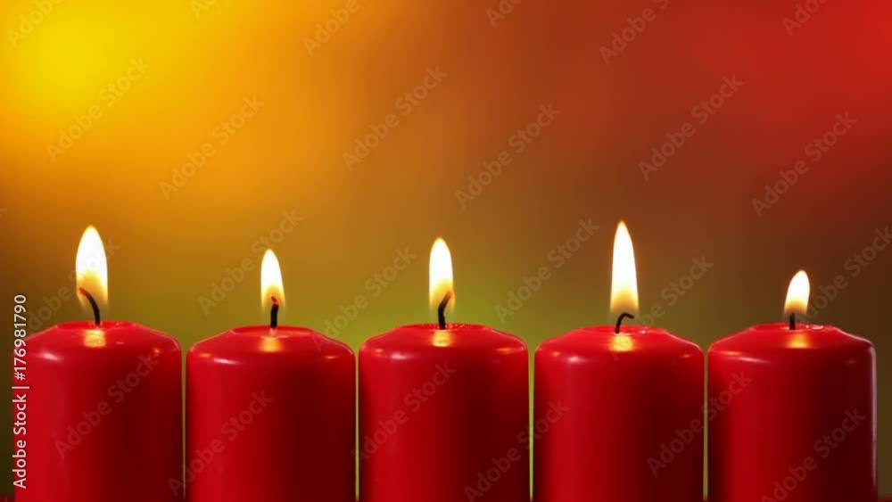 Static camera shot of five burning red xmas candles with shimmering lights against smooth blurry warm lights background - copyspace Static camera shot of five burning red xmas candles with shimmering lights against smooth blurry warm lights background - copyspace