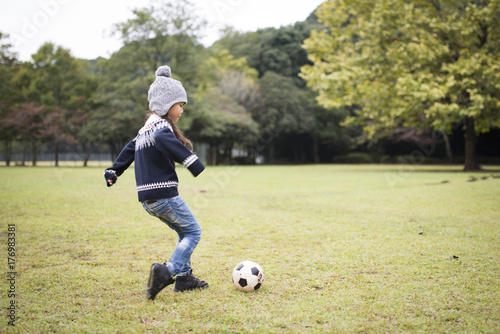 Little girl playing with a soccer ball