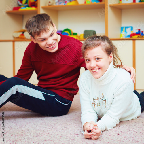 Foto smiling teenage friends with special needs talking cheerfully together in rehabi