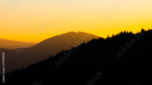 Silhouette of Tanvaldsky Spicak mountain at sunset time, Jizera Mountains, Czech Republic.