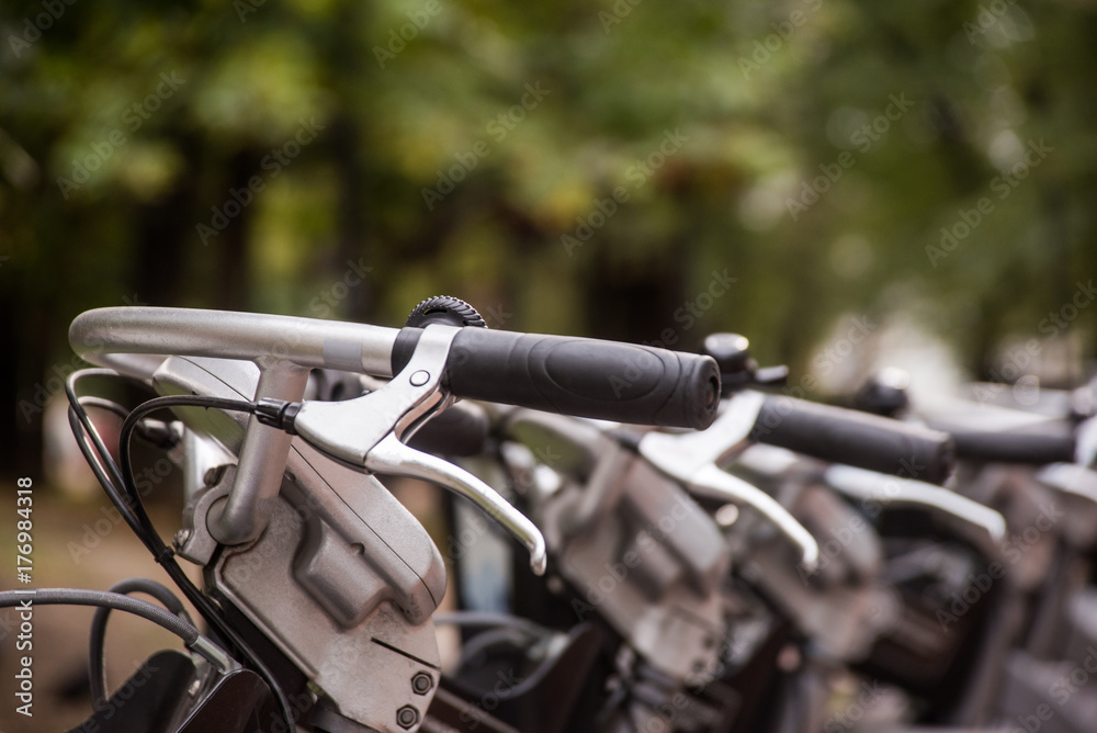 Fototapeta premium Row of city parked bikes for rent on sidewalk