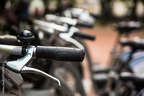 Row of city parked bikes for rent on sidewalk