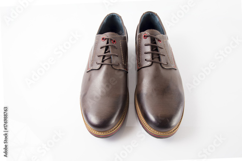 Male brown leather shoes on white background, isolated product, comfortable footwear.