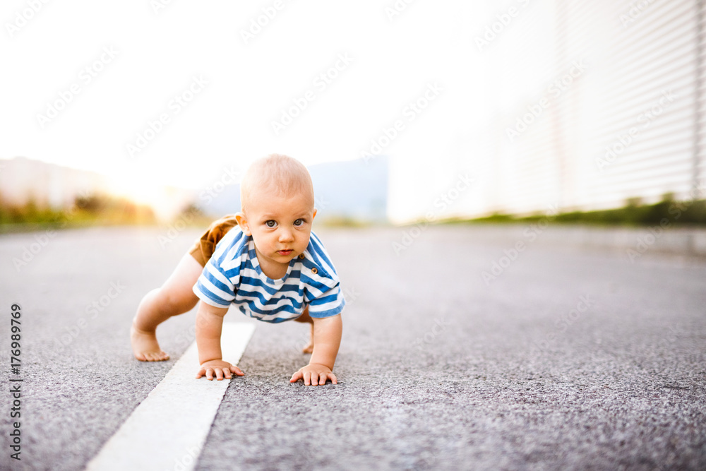 Little baby boy crawling outside on the road. Little baby boy crawling outside on the road.