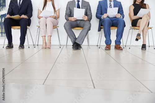 Five candidates waiting for job interviews, front view, crop