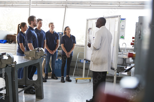 Engineering apprentices standing at a training presentation