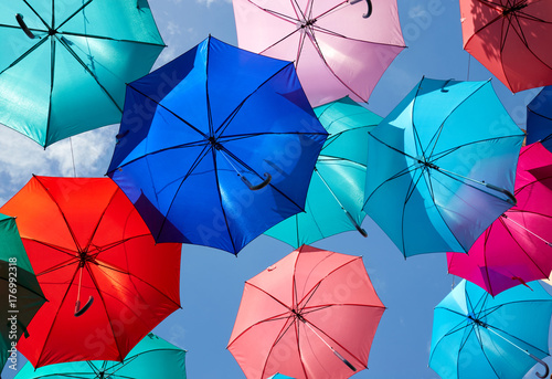 Colorful umbrellas hanging against  the sky, street decoration