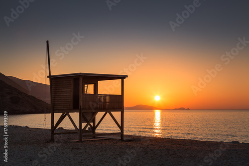 Sun setting behind lifeguard tower on Ostriconi beach in Corsica © Jon Ingall