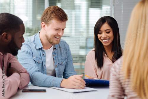 Joyful bearded man that looking at paper