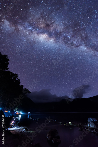 Milky Way landscape. Clearly Milky way above Lake Segara Anak inside crater of Rinjani mountain on night sky. Lombok island, Indonesia.
