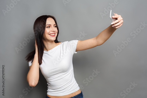 Woman taking photo with gadget, communication