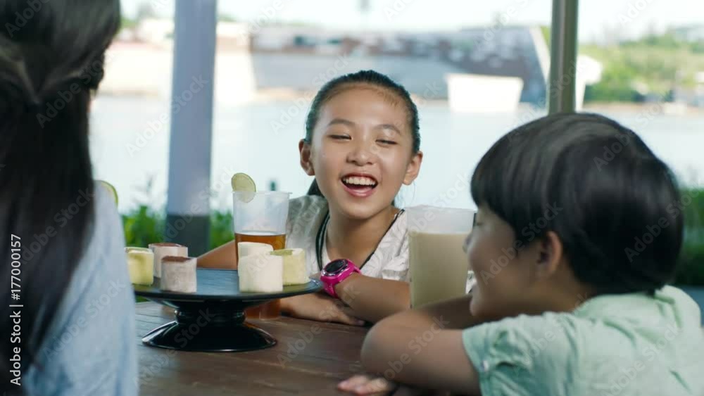 asian family drinking & talking at outdoor seating enjoying happy family time in slow motion asian family drinking & talking at outdoor seating enjoying happy family time in slow motion