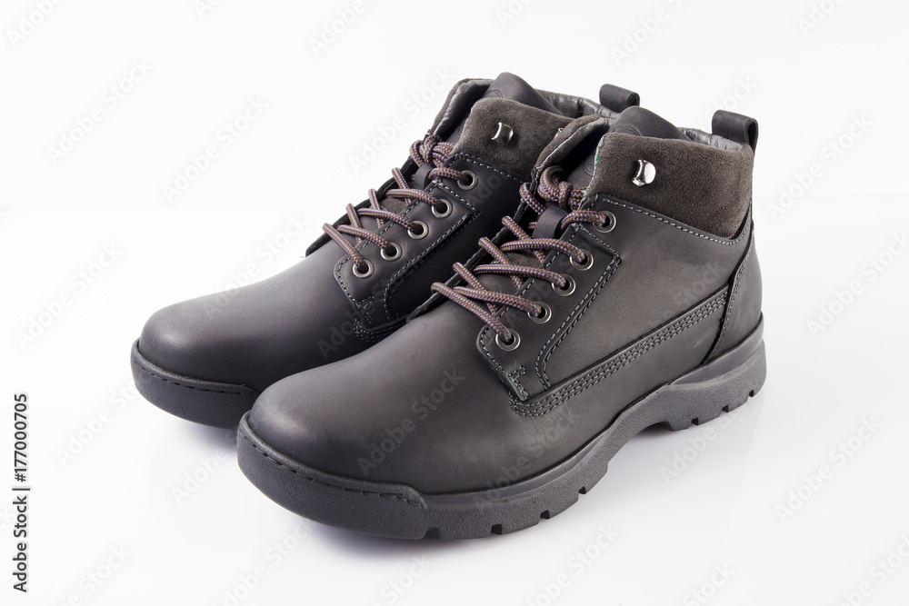 Male black leather boot on white background, isolated product. Male black leather boot on white background, isolated product.