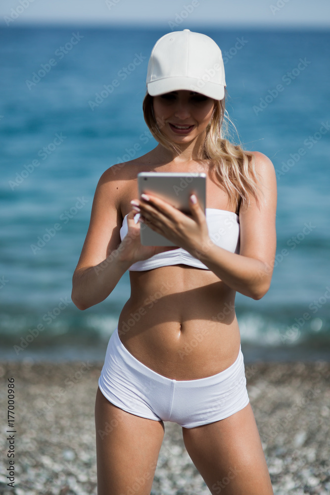 healthy gym blonde girl searches for new lifestyle fitness apps on her computer tablet healthy gym blonde girl searches for new lifestyle fitness apps on her computer tablet