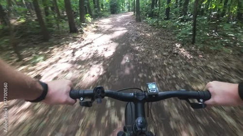 Cycling on forest road in first person