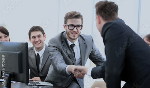 Принти на полотні business partners near your Desk to shake hands as a sign of coo