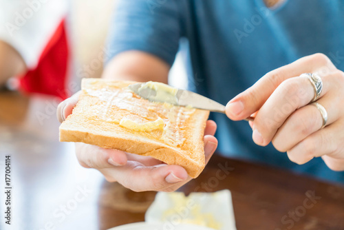 Hand holding bread and butter making for breakfast