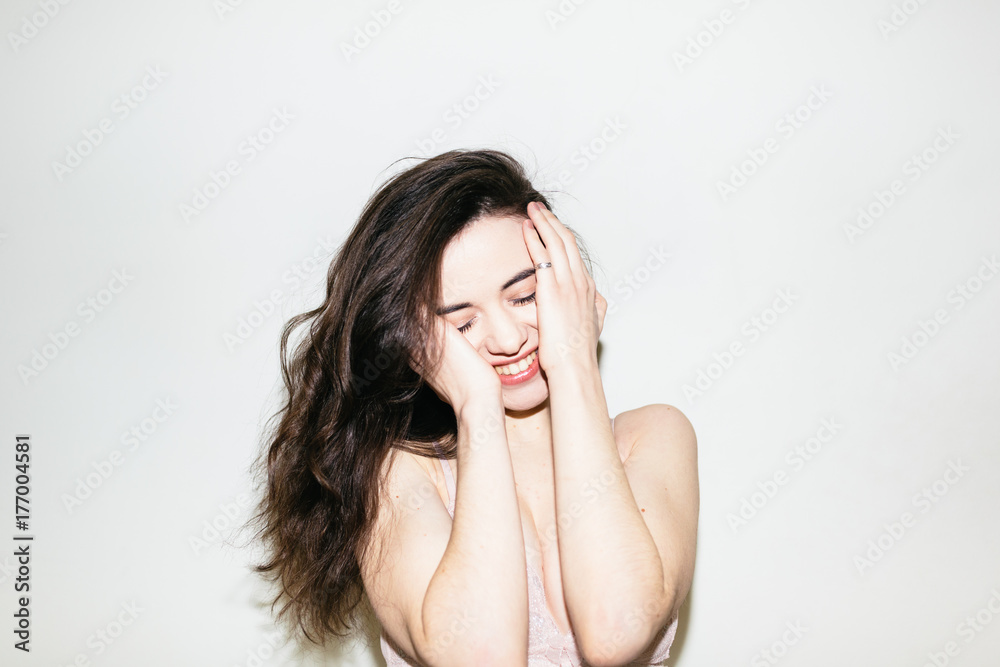 Portrait of attractive smiling woman against a white wall Portrait of attractive smiling woman against a white wall