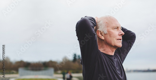 Tired senior man breathing after exercise workout photo