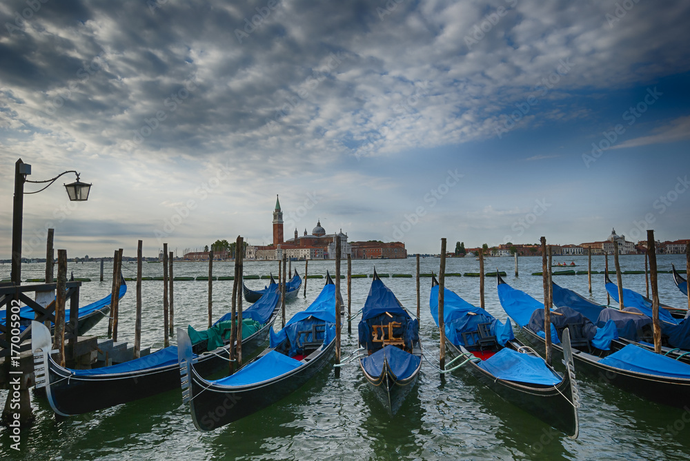 Early morning view on gondolas peers grand channel Venice Italy