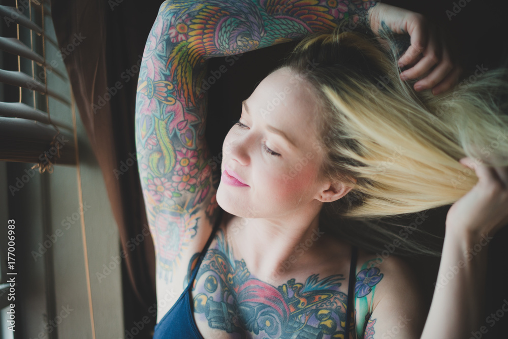 Woman by the window, feeling breeze on her neck