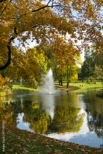 Fototapeta Naklejka Na Ścianę i Meble -  Golden autumn in a city park. Fountain in the Bastelkajna park in Riga, Latvia.