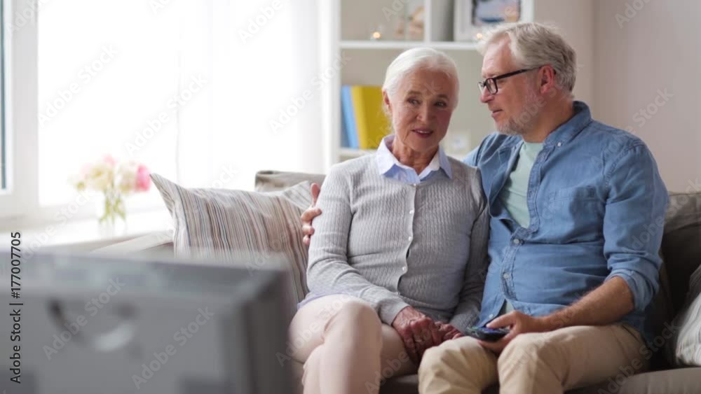 happy senior couple watching tv at home happy senior couple watching tv at home
