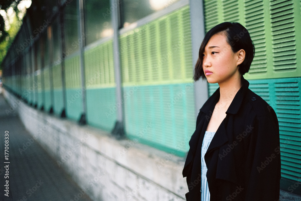 Landscape of an asian woman leaning against the wall Landscape of an asian woman leaning against the wall