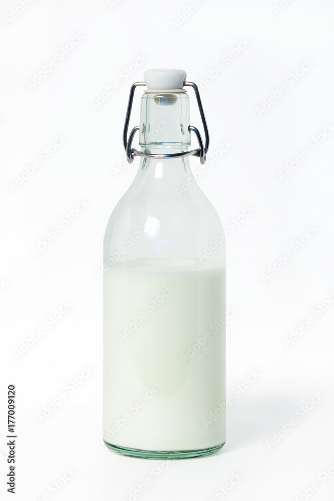 Milk in a glass bottle on a white background Milk in a glass bottle on a white background